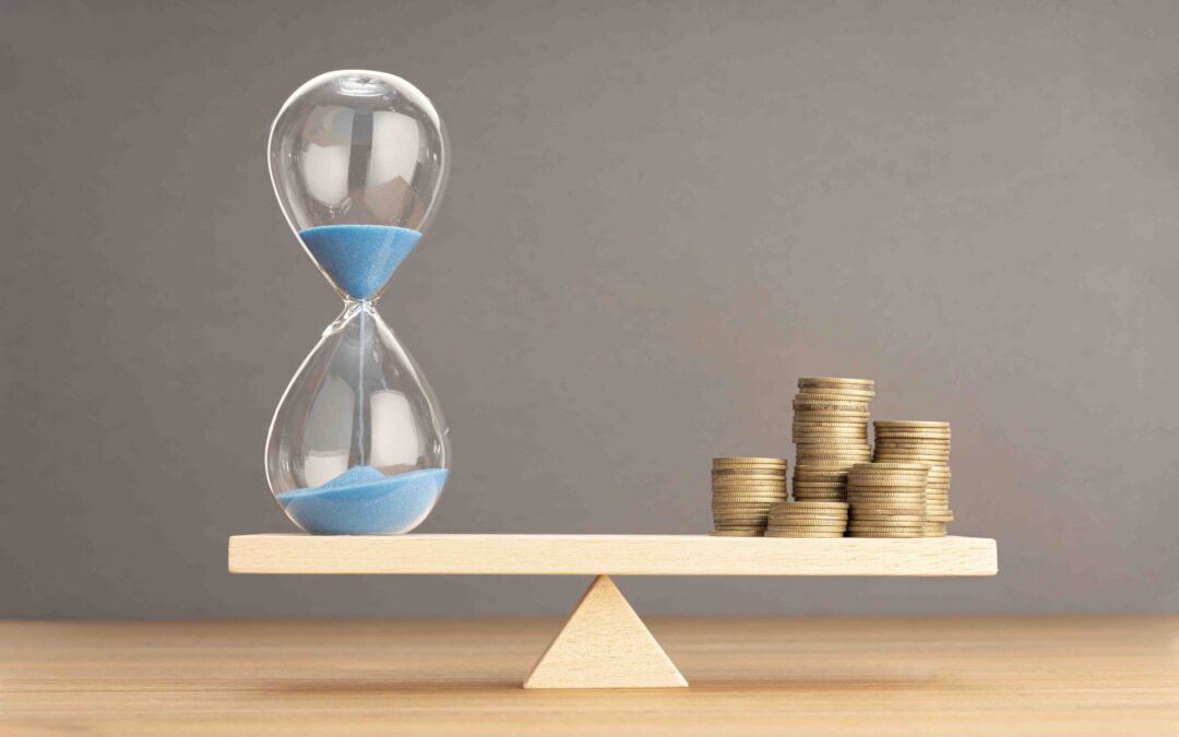 Balance Between Time and money concept. Sand clock and stacked c