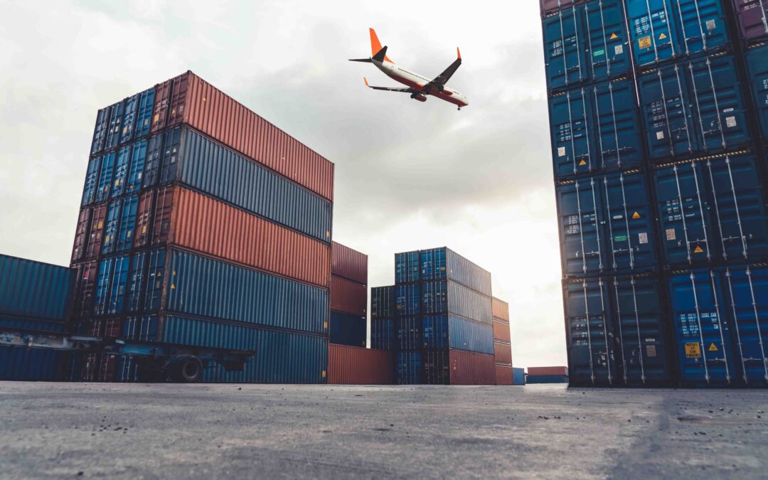 Freight airplane flying above overseas shipping container